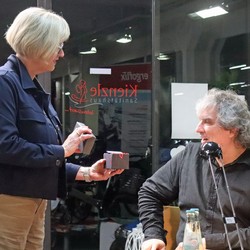 Bettina Born vom Literaturpflaster-Organisations-Team überraschte Reiseautor Joscha Remus nach der Lesung mit einem der traditionellen Literaturpflastersteine.